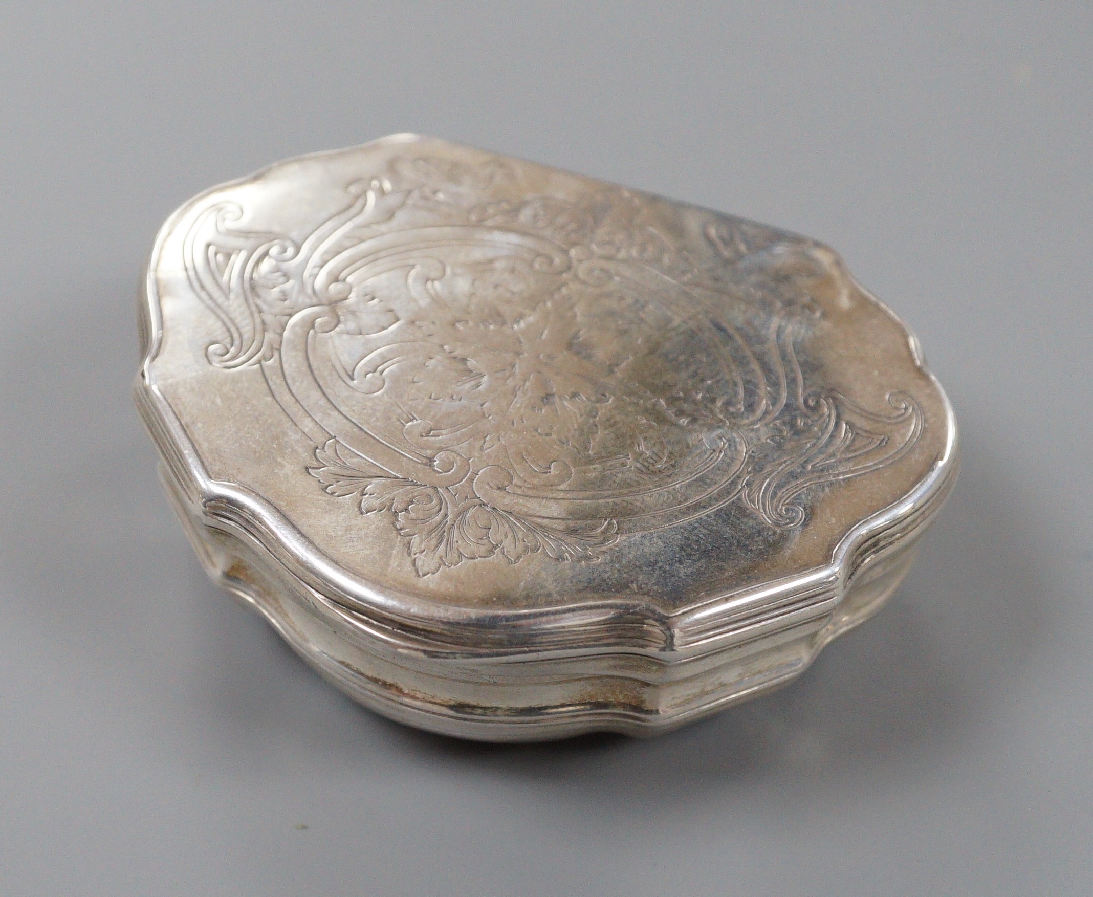 A late 18th/early 19th century white metal shaped demi-lune snuff box, makers mark, OR, 7cm, 69.5 grams.
